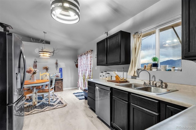 3569 County Road 19, Florence, CO 81226 - kitchen featuring stainless steel appliances, a sink, dark cabinetry, light countertops, and lofted ceiling