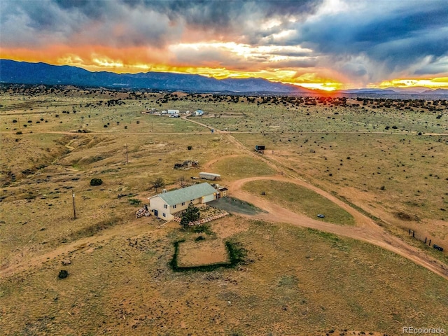 3569 County Road 19, Florence, CO 81226 - aerial overview of property's location with a mountainous background, rural landscape, and a desert landscape