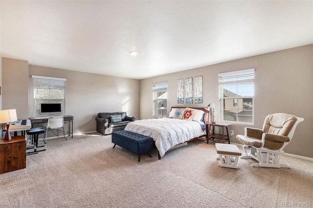 bedroom featuring baseboards, multiple windows, and carpet floors