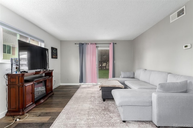10211 Ura Ln Unit 8-102, Thornton, CO 80260 - living room featuring dark wood-style flooring and a textured ceiling