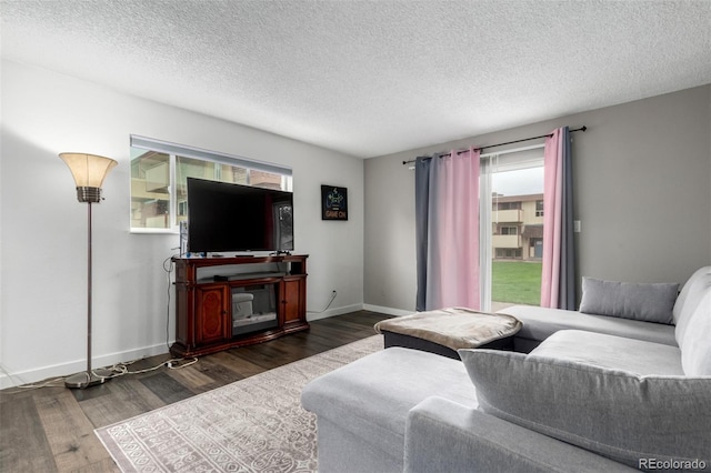 10211 Ura Ln Unit 8-102, Thornton, CO 80260 - living room featuring healthy amount of natural light, wood finished floors, and a textured ceiling