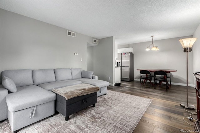 10211 Ura Ln Unit 8-102, Thornton, CO 80260 - living room with dark wood-style flooring and a textured ceiling