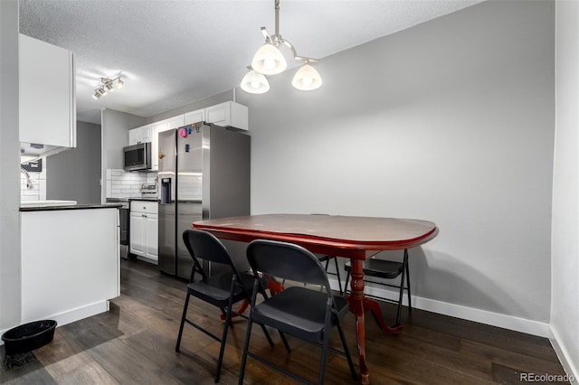 10211 Ura Ln Unit 8-102, Thornton, CO 80260 - dining room featuring a textured ceiling and dark wood-style flooring