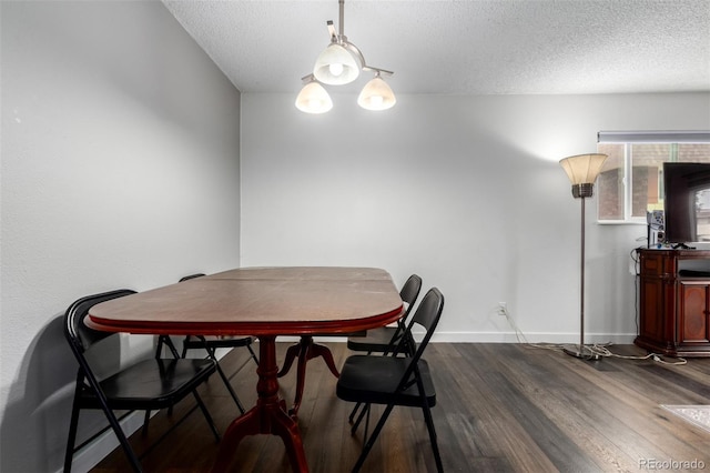 10211 Ura Ln Unit 8-102, Thornton, CO 80260 - dining area featuring dark wood-style floors and a textured ceiling