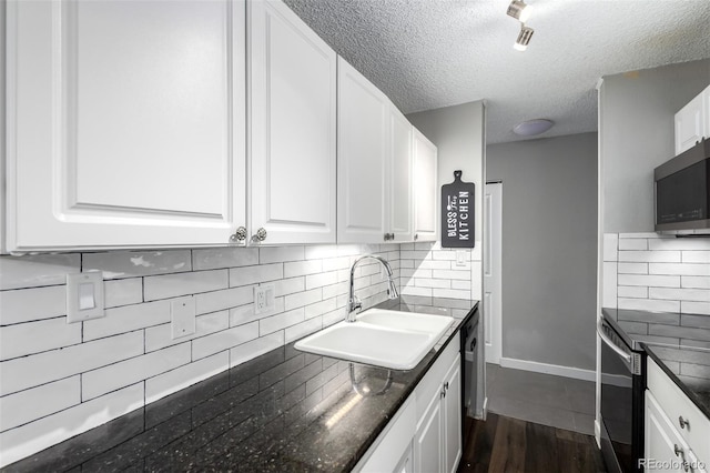 10211 Ura Ln Unit 8-102, Thornton, CO 80260 - kitchen featuring white cabinets, decorative backsplash, a textured ceiling, dark wood-style floors, and electric range