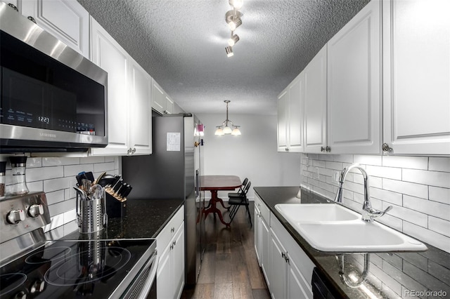 10211 Ura Ln Unit 8-102, Thornton, CO 80260 - kitchen with stainless steel appliances, dark wood-style flooring, white cabinets, a textured ceiling, and decorative backsplash