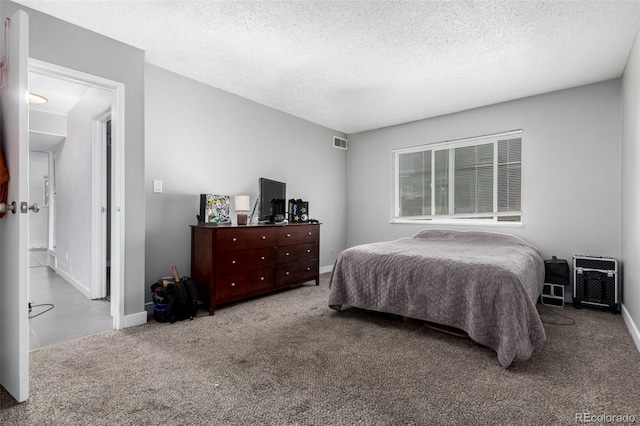 10211 Ura Ln Unit 8-102, Thornton, CO 80260 - carpeted bedroom featuring baseboards and a textured ceiling