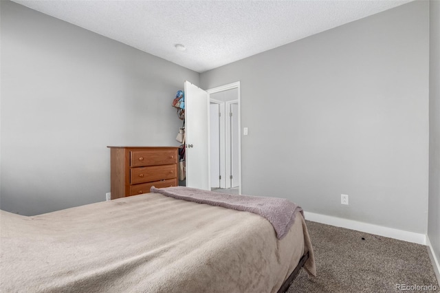 10211 Ura Ln Unit 8-102, Thornton, CO 80260 - carpeted bedroom featuring baseboards and a textured ceiling