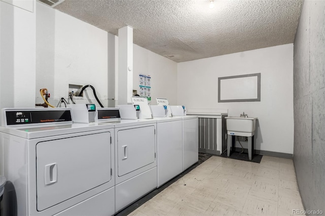 10211 Ura Ln Unit 8-102, Thornton, CO 80260 - shared laundry featuring washer and dryer, light flooring, and a textured ceiling