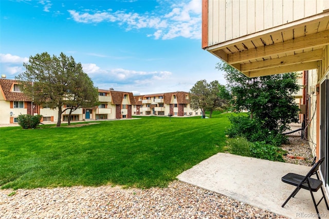 10211 Ura Ln Unit 8-102, Thornton, CO 80260 - view of grassy yard featuring a patio area and a residential view