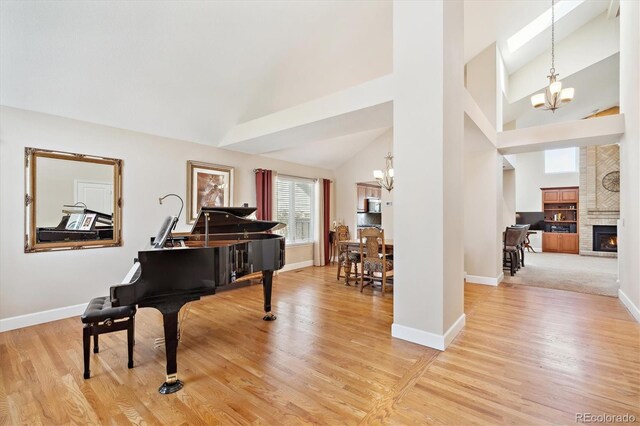 interior space with an inviting chandelier, baseboards, and light wood-type flooring