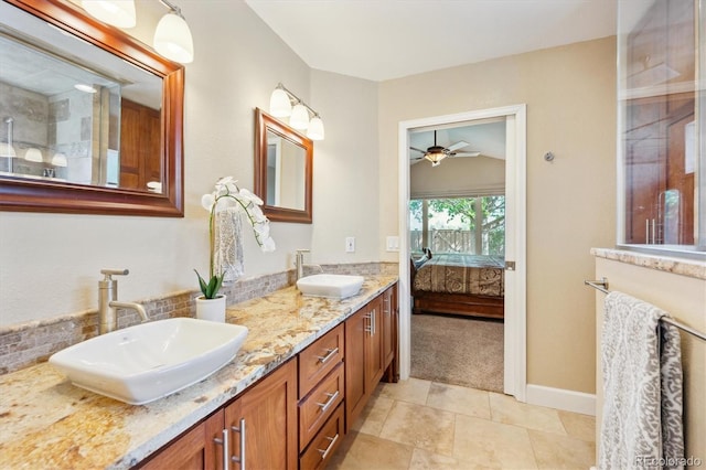 ensuite bathroom with a sink, a ceiling fan, ensuite bath, and double vanity