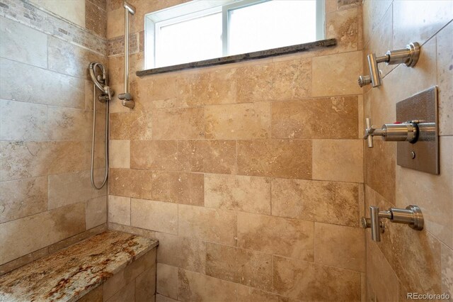 full bathroom with tiled shower