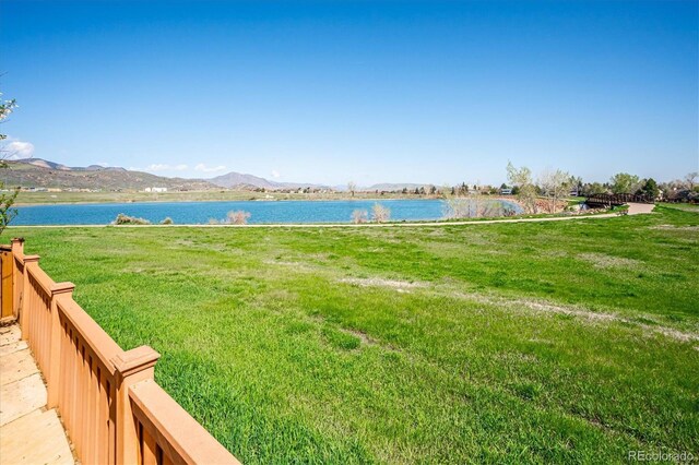 view of yard featuring a water and mountain view