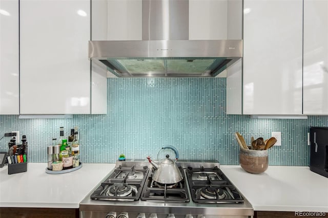 3168 W 29th Ave, Denver, CO 80211 - kitchen featuring ventilation hood, backsplash, stove, and light countertops