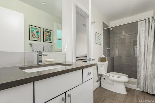 3168 W 29th Ave, Denver, CO 80211 - bathroom with toilet, vanity, a tile shower, and wood finished floors