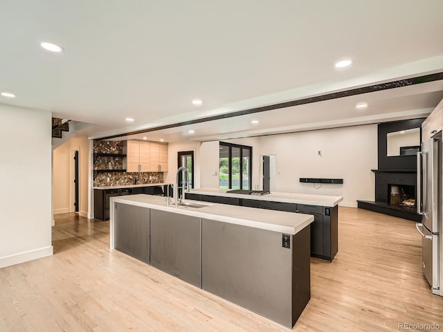 22 Rangeview Dr, Wheat Ridge, CO 80215 - kitchen featuring a large island, recessed lighting, light countertops, tasteful backsplash, and light wood-type flooring
