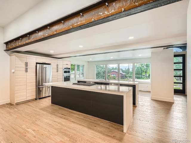 22 Rangeview Dr, Wheat Ridge, CO 80215 - kitchen featuring appliances with stainless steel finishes, modern cabinets, light wood-style floors, light countertops, and recessed lighting
