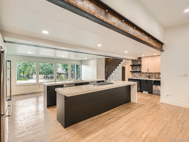 22 Rangeview Dr, Wheat Ridge, CO 80215 - kitchen with a large island, light countertops, appliances with stainless steel finishes, recessed lighting, and backsplash