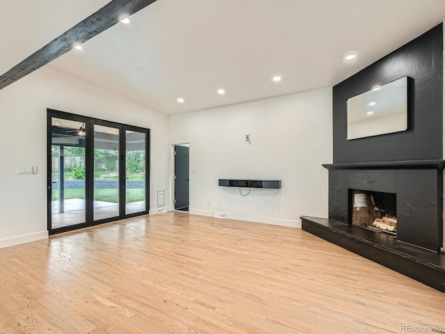 22 Rangeview Dr, Wheat Ridge, CO 80215 - unfurnished living room featuring light wood-type flooring, recessed lighting, a high end fireplace, and beam ceiling