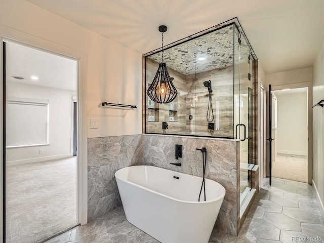 22 Rangeview Dr, Wheat Ridge, CO 80215 - bathroom with a freestanding bath, a shower stall, and tile walls