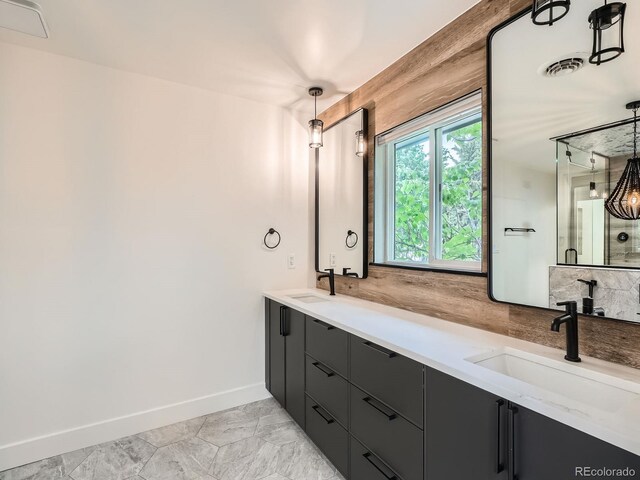 22 Rangeview Dr, Wheat Ridge, CO 80215 - bathroom with double vanity and marble look tile flooring