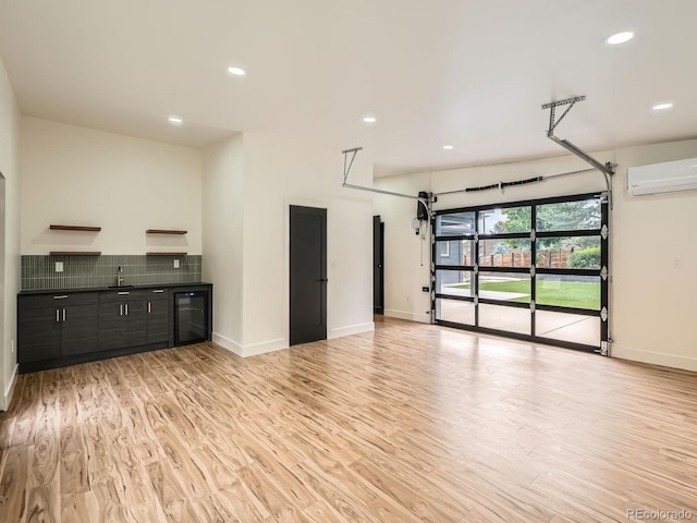 22 Rangeview Dr, Wheat Ridge, CO 80215 - unfurnished living room featuring a wall unit AC, light wood-type flooring, recessed lighting, and a garage