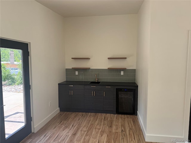 22 Rangeview Dr, Wheat Ridge, CO 80215 - indoor bar featuring wine cooler, decorative backsplash, and light wood-style floors