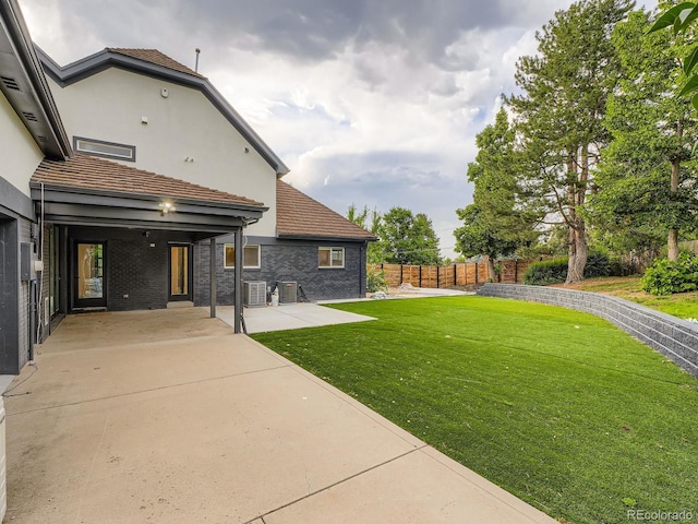 22 Rangeview Dr, Wheat Ridge, CO 80215 - fenced backyard featuring a patio area and driveway