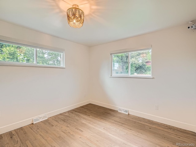 22 Rangeview Dr, Wheat Ridge, CO 80215 - empty room with a chandelier and light wood-style flooring