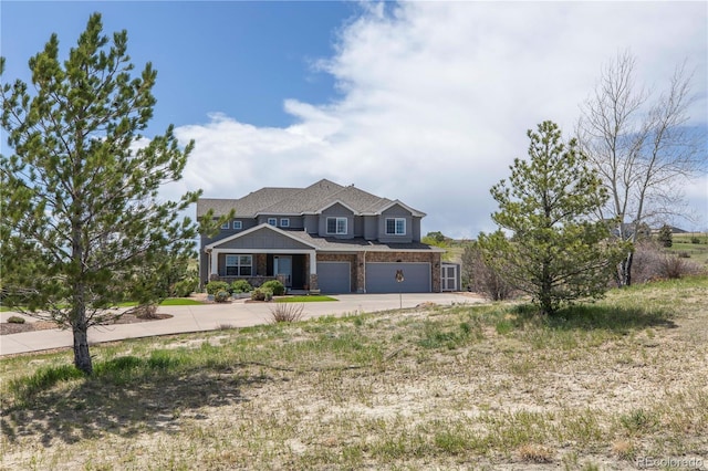 2339 Elkhorn St, Parker, CO 80138 - view of front facade with concrete driveway, a garage, and stone siding