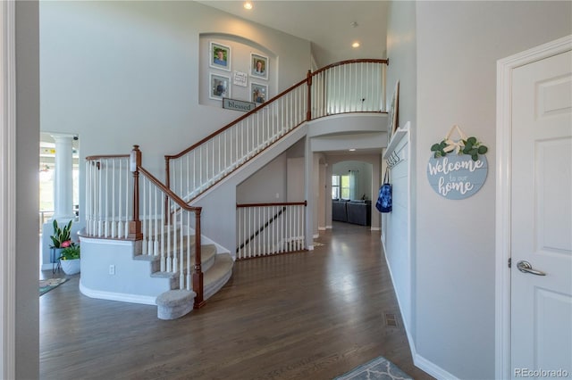 2339 Elkhorn St, Parker, CO 80138 - foyer entrance featuring wood finished floors, a towering ceiling, stairs, arched walkways, and recessed lighting