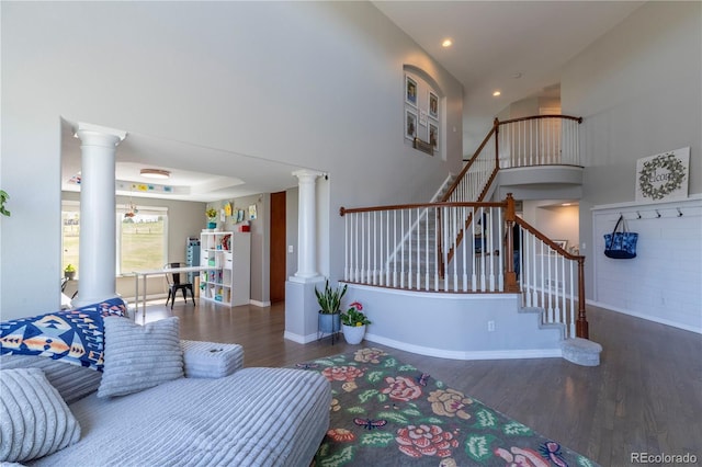 2339 Elkhorn St, Parker, CO 80138 - living area with ornate columns, wood finished floors, stairs, a high ceiling, and recessed lighting