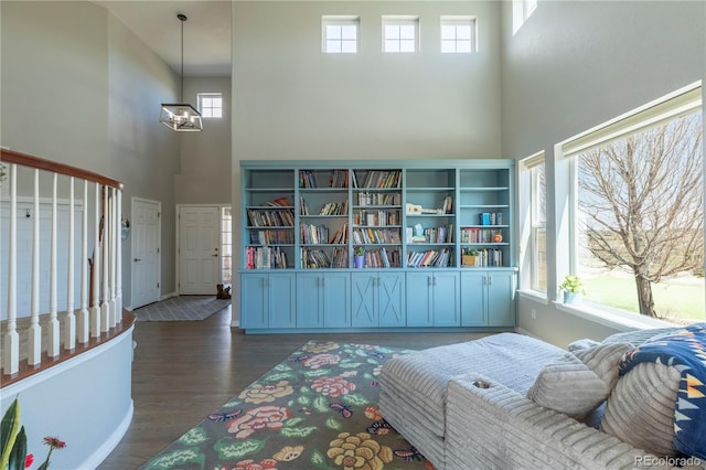 2339 Elkhorn St, Parker, CO 80138 - living area featuring a towering ceiling, wood finished floors, a chandelier, and baseboards