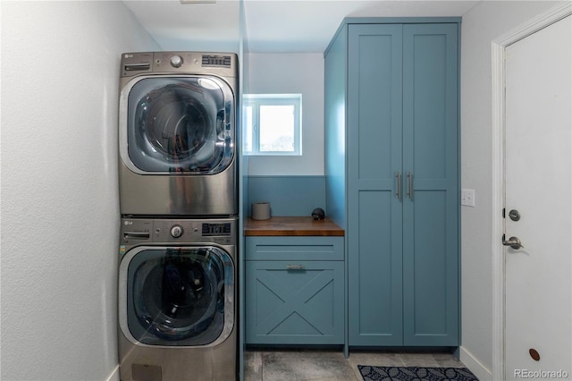 2339 Elkhorn St, Parker, CO 80138 - laundry room featuring stacked washer / dryer, cabinet space, and baseboards