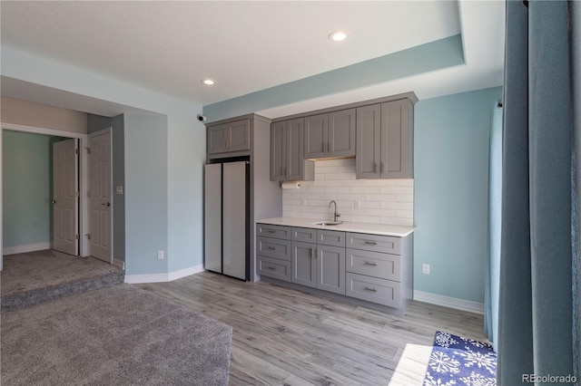 2339 Elkhorn St, Parker, CO 80138 - kitchen featuring freestanding refrigerator, gray cabinetry, light countertops, decorative backsplash, and a sink