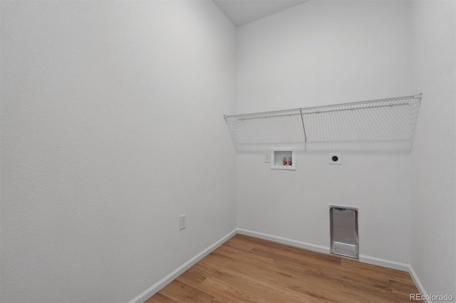 clothes washing area with hookup for an electric dryer, hardwood / wood-style flooring, and washer hookup