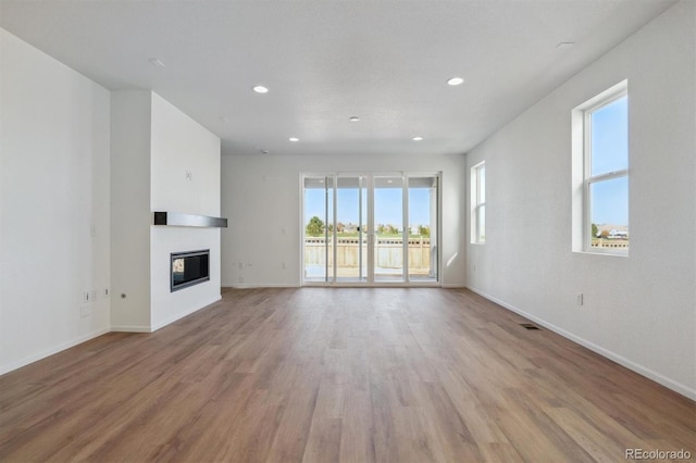 unfurnished living room with light hardwood / wood-style floors