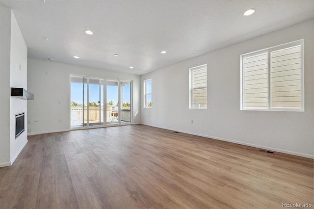 unfurnished living room featuring light hardwood / wood-style floors