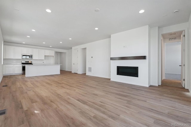 unfurnished living room with light wood-type flooring