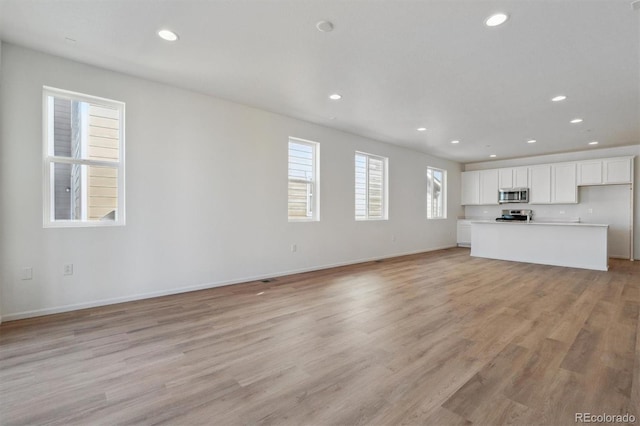 unfurnished living room with light wood-type flooring