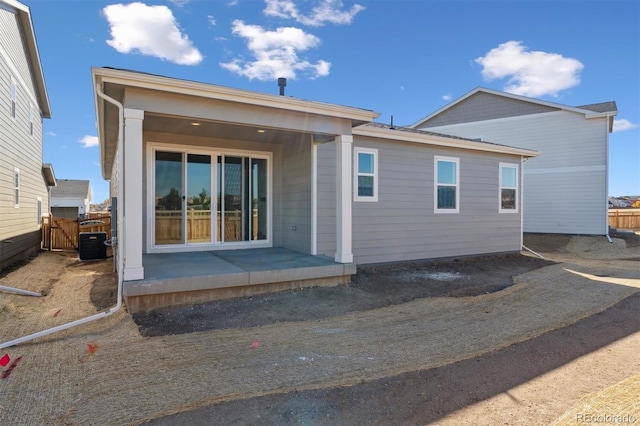 back of house featuring central AC unit