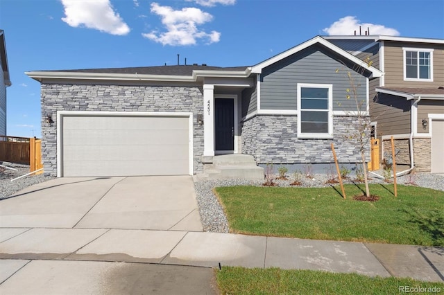 view of front of property with a garage and a front lawn