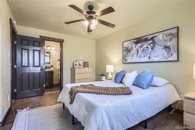 bedroom featuring connected bathroom, dark hardwood / wood-style floors, and ceiling fan