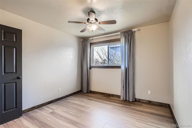 spare room with light hardwood / wood-style flooring and ceiling fan