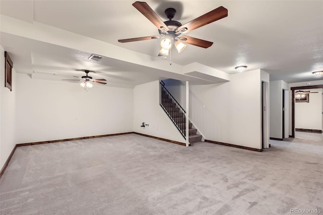 interior space featuring ceiling fan and light colored carpet