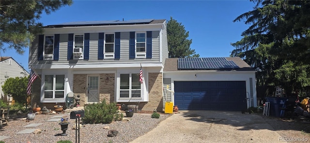 1024 S Mobile St, Aurora, CO 80017 - view of front of property featuring roof mounted solar panels, brick siding, driveway, a garage, and covered porch