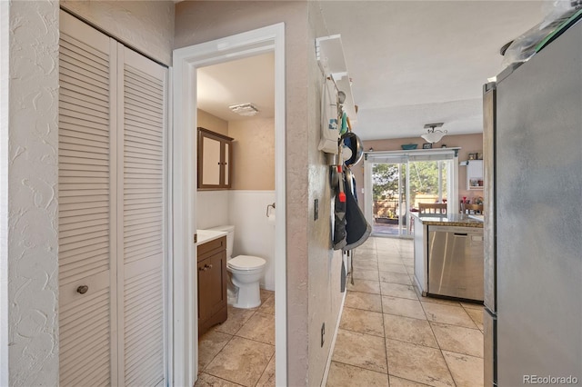 1024 S Mobile St, Aurora, CO 80017 - bathroom featuring a closet, vanity, and wainscoting
