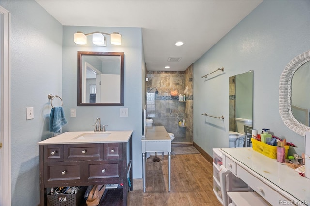 1024 S Mobile St, Aurora, CO 80017 - bathroom with a stall shower, wood finished floors, vanity, and recessed lighting