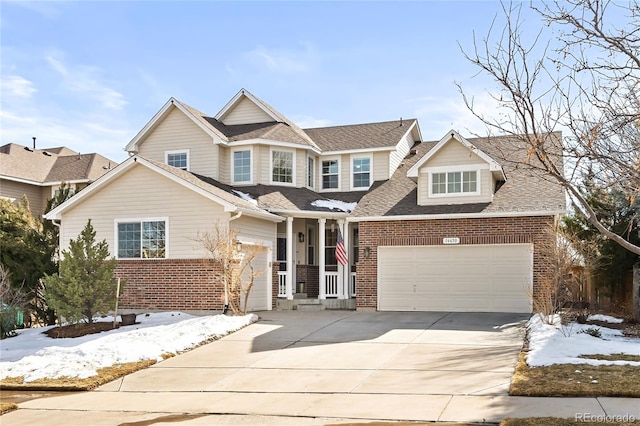 view of front of house with a garage, driveway, brick siding, and a shingled roof